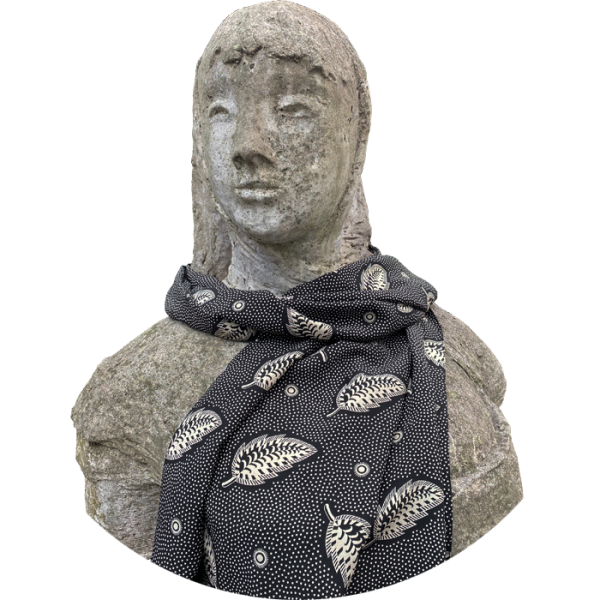 A graphic Cressida Bell silk shawl made in the UK from luxurious 100% silk crepe de chine printed with a hand-painted Stripey Leaf design in Black, bringing a touch of maximalism to any look  photographed on a bust by Quentin Bell